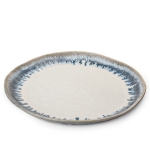 Burlington Dinner Plate, Pool Simon Pearce has channeled the earthy spirit of Burlington with a collection of freehand pinch-pot designs. Each piece is alive with mottled, tactile uniqueness – including this rustic dinner plate. The organic drip technique of their Pool glaze nods to modern art with a deep blue hue emanating from the edges. These truly one-of-a-kind pieces add a pop of color to existing Burlington pottery, or make a bold statement on their own.